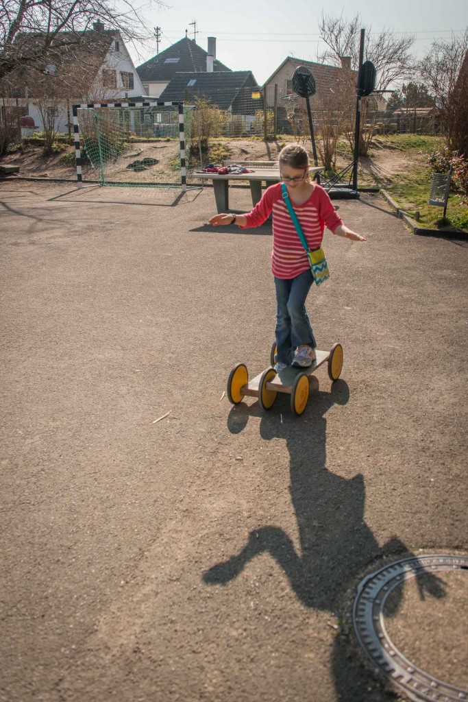 Phoenix plays with the Pedalgo toy in the elementary school yard.