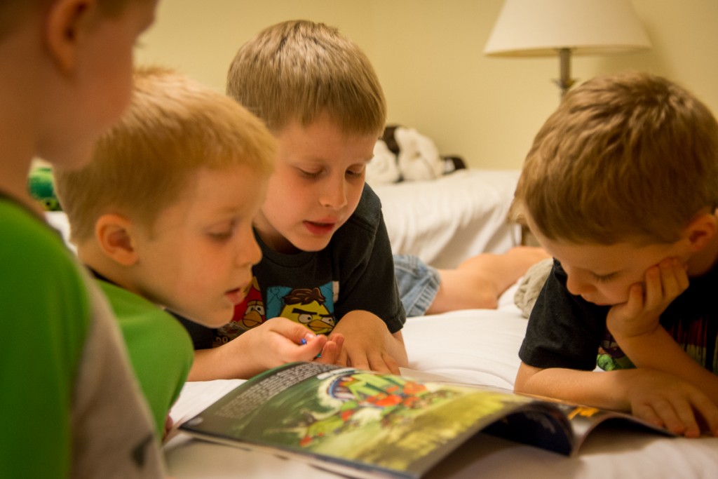 Cyclops reads to the other boys. Nevermind he's reading a book about all the characters in the Ninjago world--he's being nice to all three of them at the same time--that's a win!
