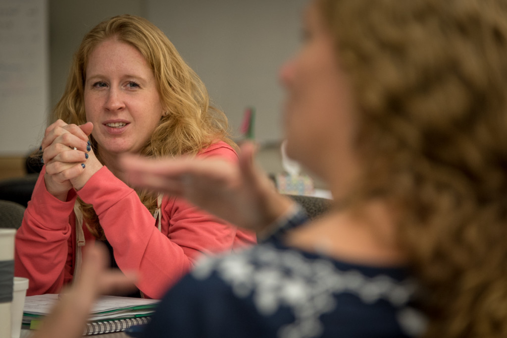 Miranda and one of her group's table leaders discuss issues during our morning training sessions.