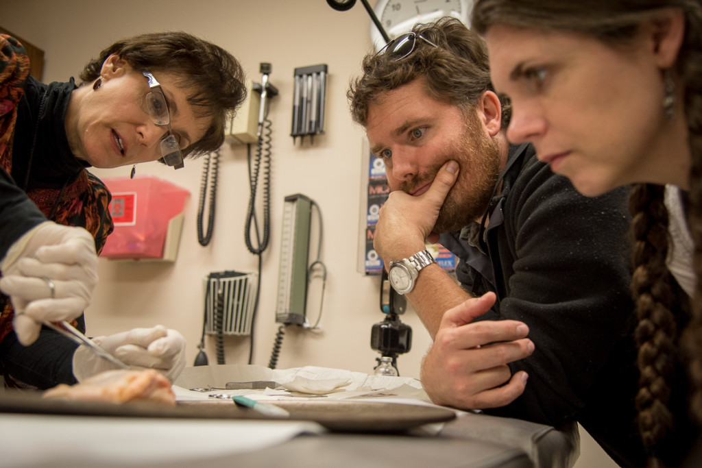 Our instructor shows us how to properly angle the needle on the suture to ensure it goes through the wound properly. It was fun practicing on dinner.