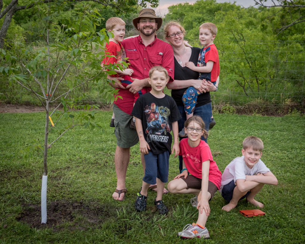 The family poses next to one of two trees we planted at Dale's dad's home a few weeks ago.